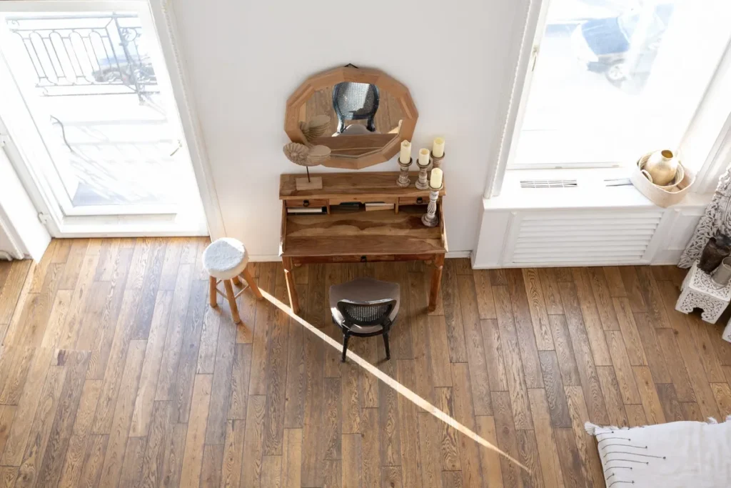 Bright two-storey apartment with wood floors and Bali-style decor, highlighting the importance of floor restoration.