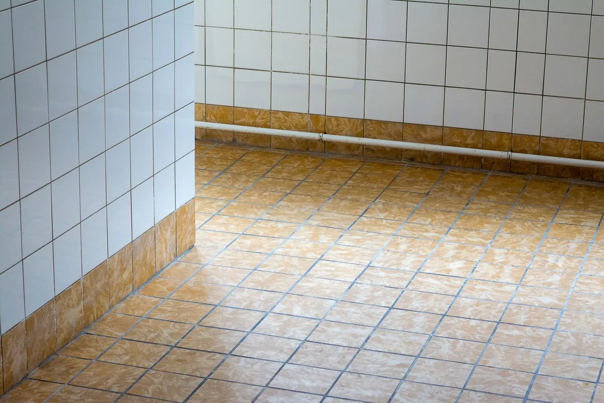 A clean, empty room with tiled flooring and minimalist design, illustrating the results of floor restoration.